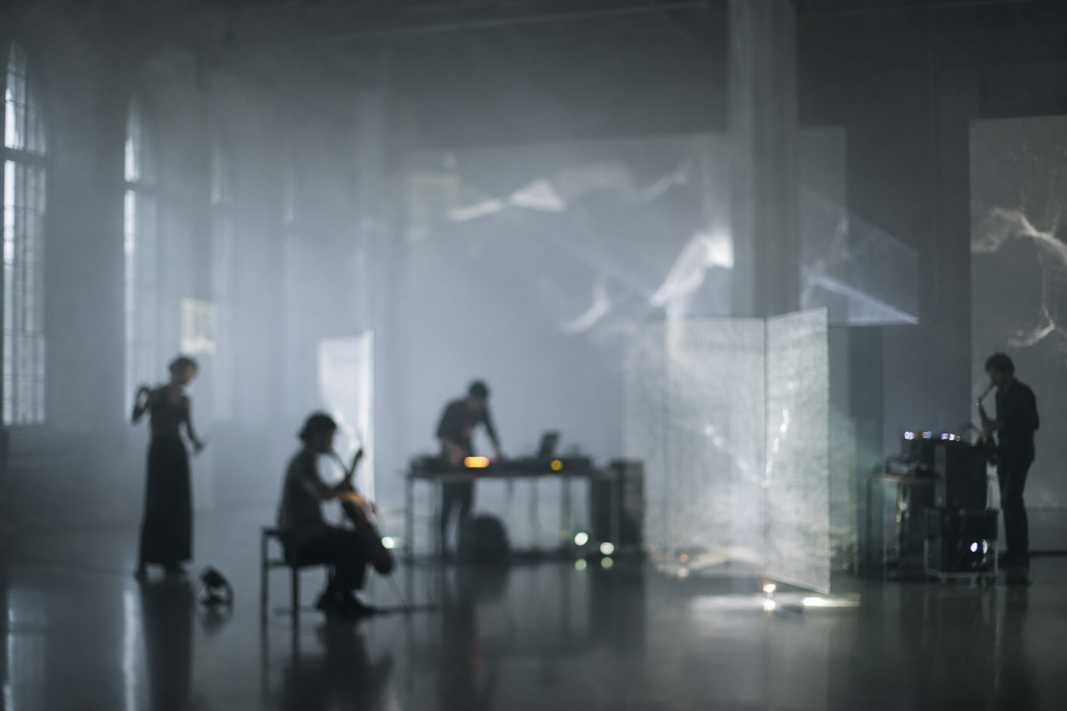 Interdisciplinary stage work with performers, musicians, projection, and live sound